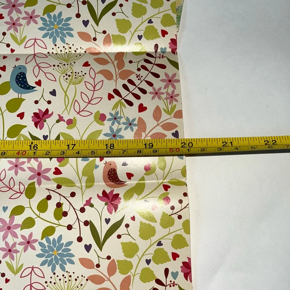 NWOT 15 sheets of flowered wrapping paper. Most sheets are 20” x 30”, at a min